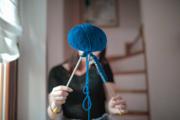 istock Young woman knitting 1043175400