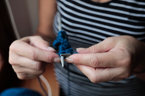 Woman knitting, close up on hands motion
