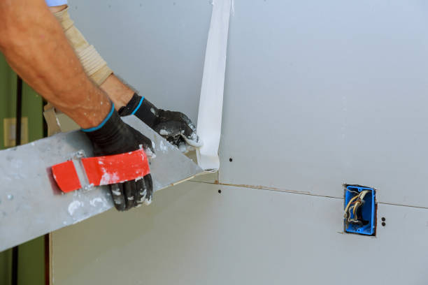 istock apartment interior construction worker plastering gypsum board wall 1043191224