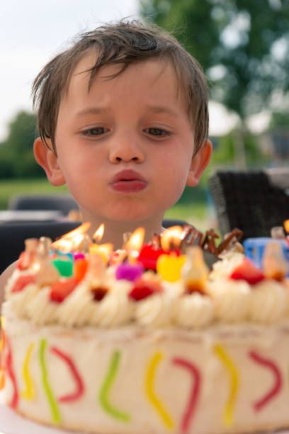 istock boy in frond of birthday cake 1043191756