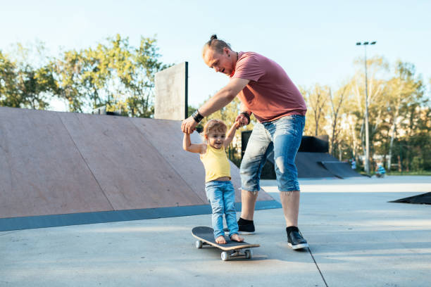 istock Super-cool dad with son in skate park 1043194658