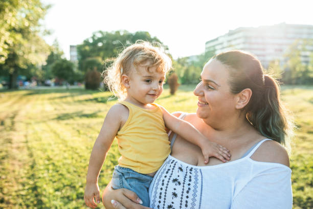 istock Overweight mother and her three year old son in the park 1043194870