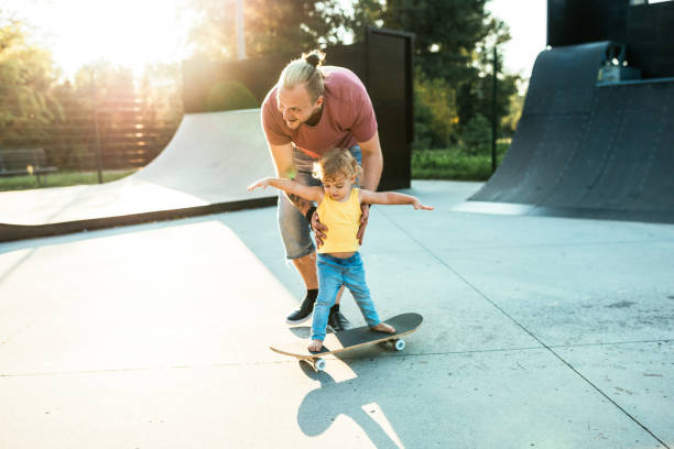 istock Super-cool dad with son in skate park 1043197956