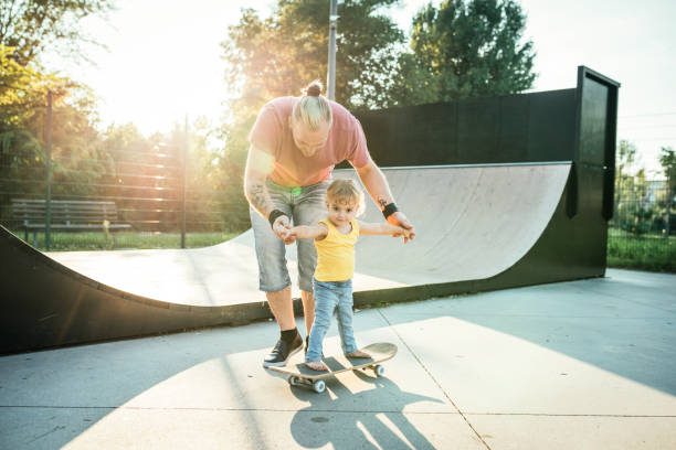 istock Super-cool dad with son in skate park 1043197998