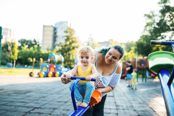 istock Overweight mother and her son playing in the park 1043198988