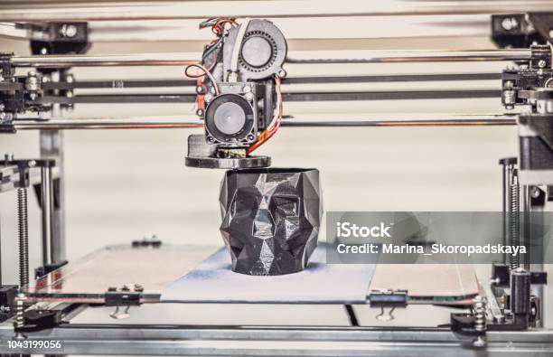 3d Printer Printing A Model In The Form Of Black Skull Closeup Stock Photo - Download Image Now