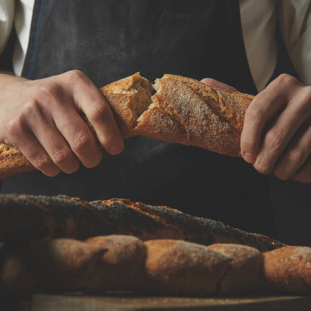 organic delicious baguette halves in the hands of man
