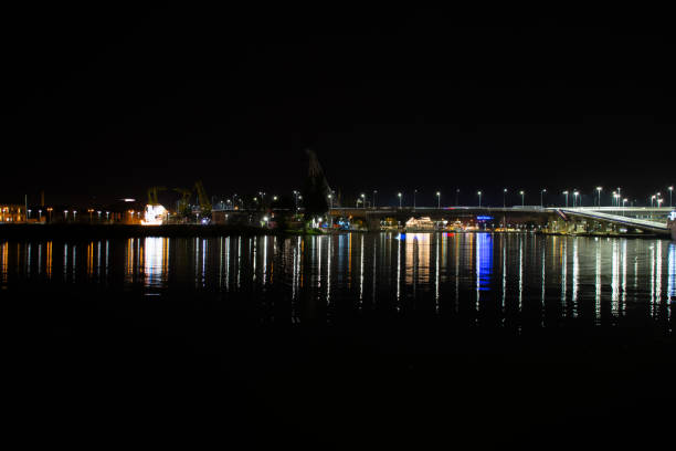 istock night lights of buildings and bridge reflection on river water 1043202820