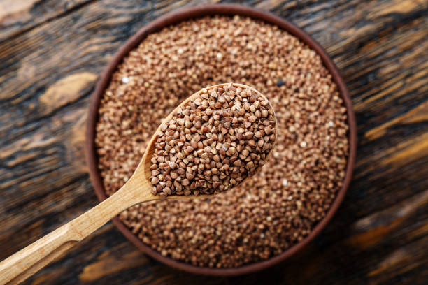 istock raw buckwheat in a plate on a wooden table. 1043207068