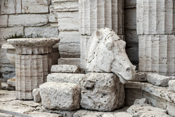greek ruins close-up. ancient columns and the stone head of a horse