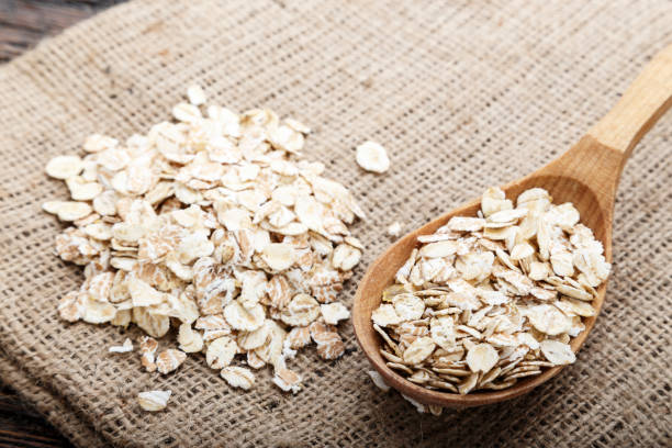 istock raw oatmeal scattered on burlap close-up. cooking breakfast oatmeal. 1043209774