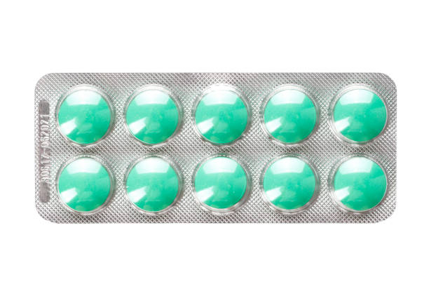 istock blister with green pills on a white background. isolated. 1043211898