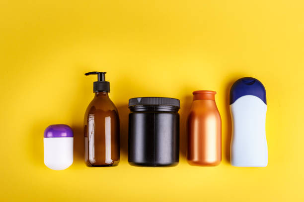 istock different bottles with cosmetics for a bath on a yellow background. 1043211916