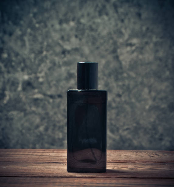 istock A perfume bottle on a wooden shelf against a gray concrete wall. 1043212640