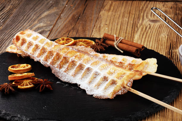 istock Belgium waffles with powder sugar. popsicles with chocolate and wafer. 1043212980
