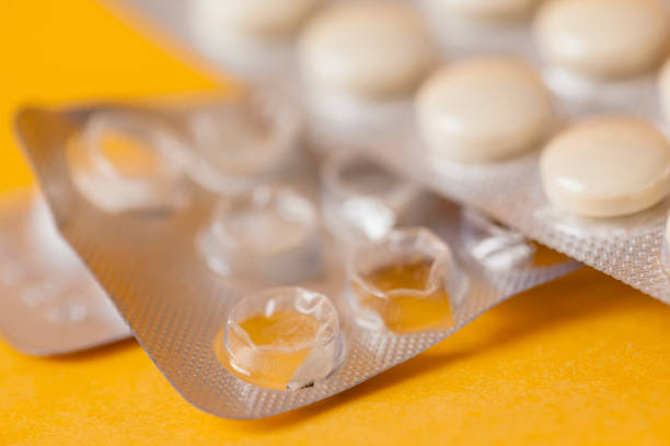 Medical tablets on yellow stock photo