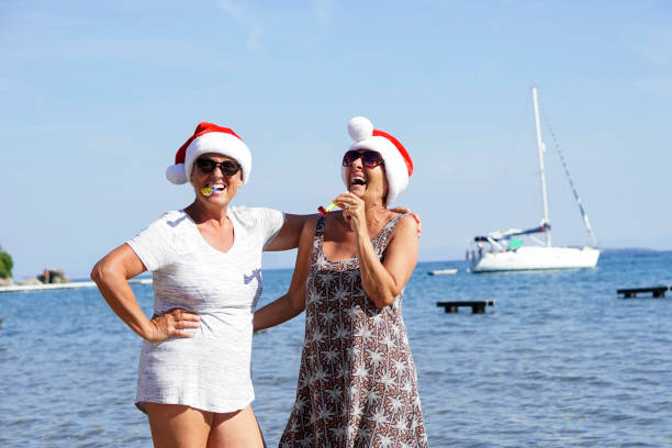 Senior women having Christmas on the beach.