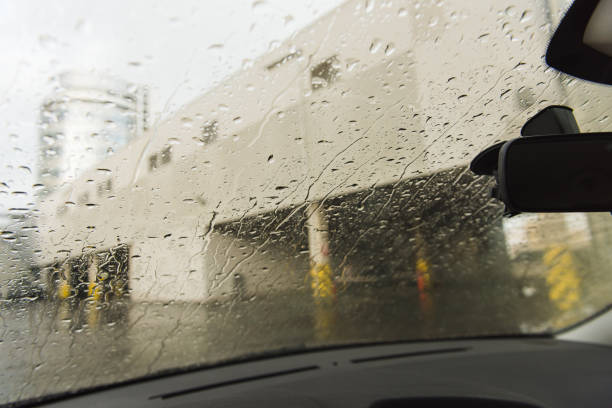 istock Water rain streams and drops at car window 1043218384