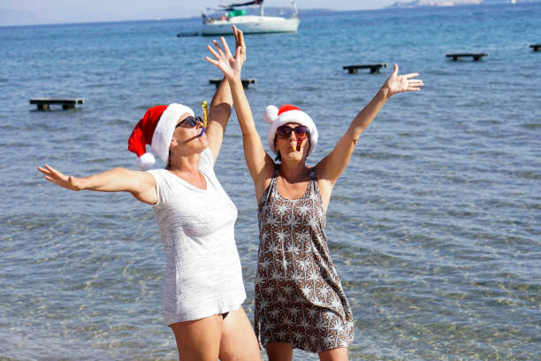 Senior women having Christmas on the beach.