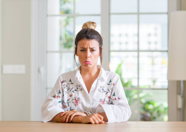istock Young woman at home depressed and worry for distress, crying angry and afraid. Sad expression. 1043227642