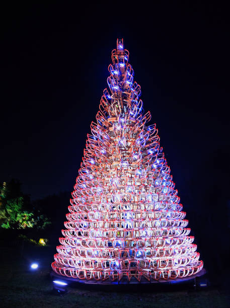 Christmas Tree in Kew Gardens at Christmas Kew Gardens, London, December 2018.  Christmas tree illuminated with lots at night.  Christmas at Kew is a popular event and attracts a large amount of tourists. kew gardens stock pictures, royalty-free photos & images