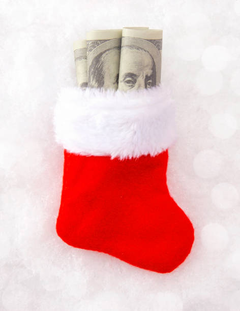 istock Christmas Stocking Stuffed with Hundred Dollar Bills 1043228986