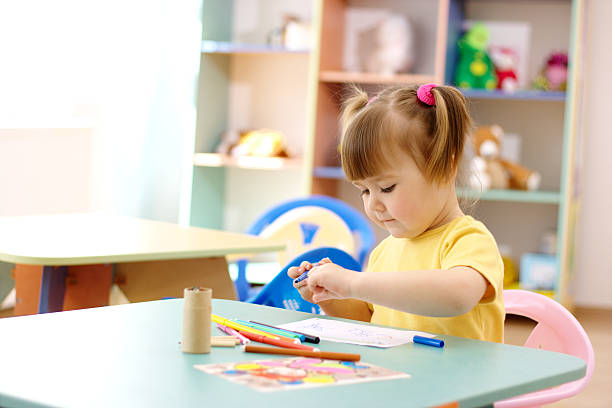 Little girl draw with color markers stock photo