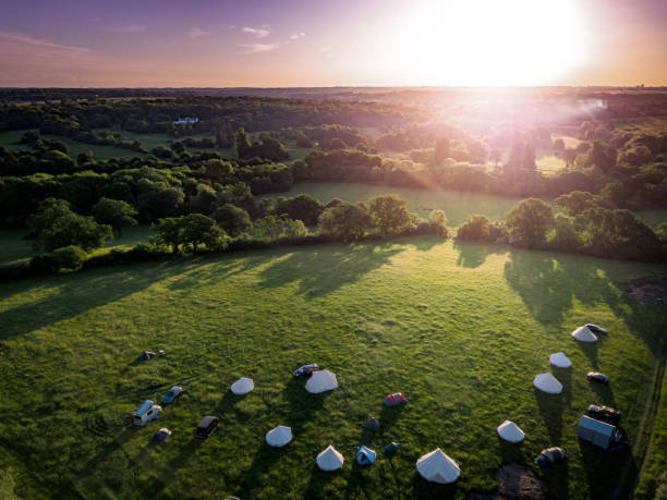 Aerial view of idyllic campsite at sunset with North London countryside as the backdrop. stock photo