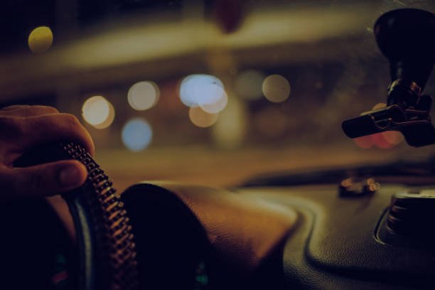 istock Driving a car at night, bokeh color 1043239336