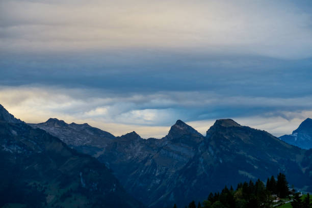 istock Alpine scene in the Swiss mountains: Sunset and storm clouds 1043244736