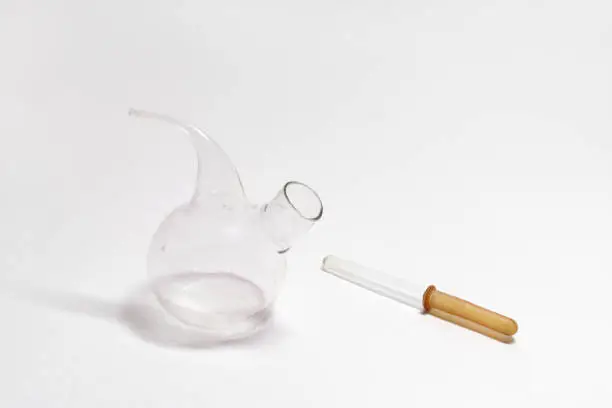 chemical droppers: Pasteur pipette (glass tube with brown rubber tip), laboratory flask with long thin spout, round-shaped body, flat bottom and side neck for filling, without stopper