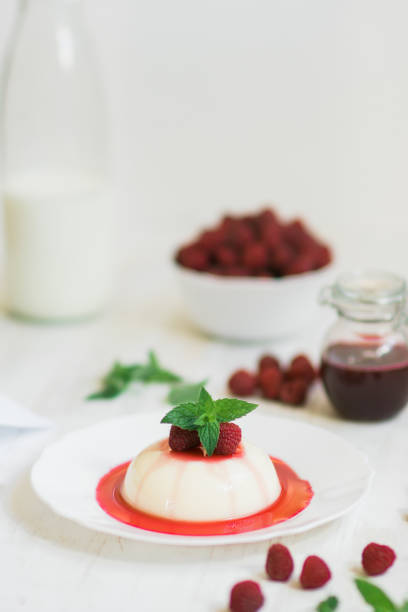 istock Light background. Close up. Vertical shot. Summer dessert. Panakota with raspberries. 1043270494