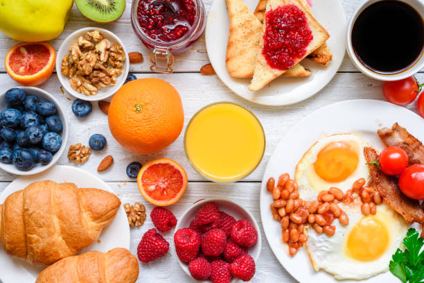 istock Breakfast including coffee, fried egg ,bacon, beans, croissant, orange juice with nuts, fruits and berries 1043275190