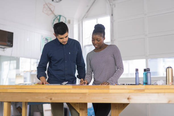istock Design couple strategize in their modern studio 1043276750