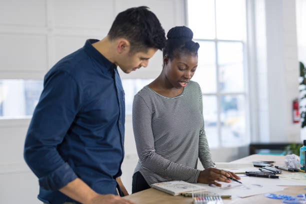 istock Design couple strategize in their modern studio 1043276752