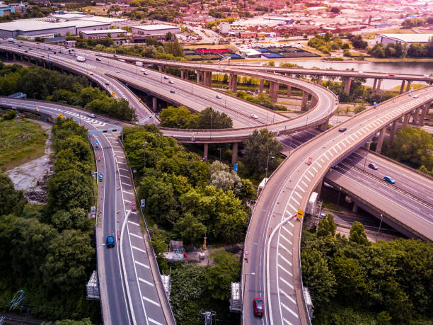 istock Motorway complex road junction aerial view with traffic moving in the UK 1043279174
