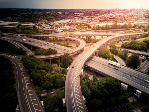istock Motorway complex road junction aerial view with traffic moving in the UK 1043279178