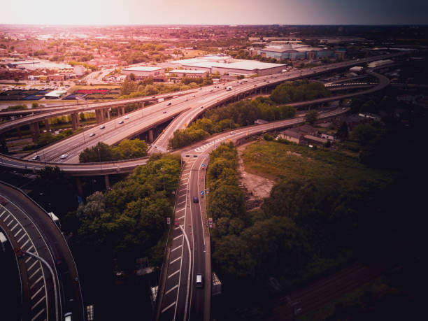 istock Motorway complex road junction aerial view with traffic moving in the UK 1043279184