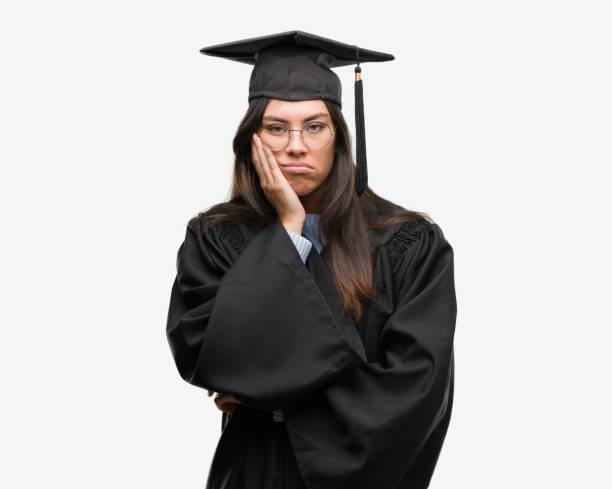 istock Young hispanic woman wearing graduated cap and uniform thinking looking tired and bored with depression problems with crossed arms. 1043292670