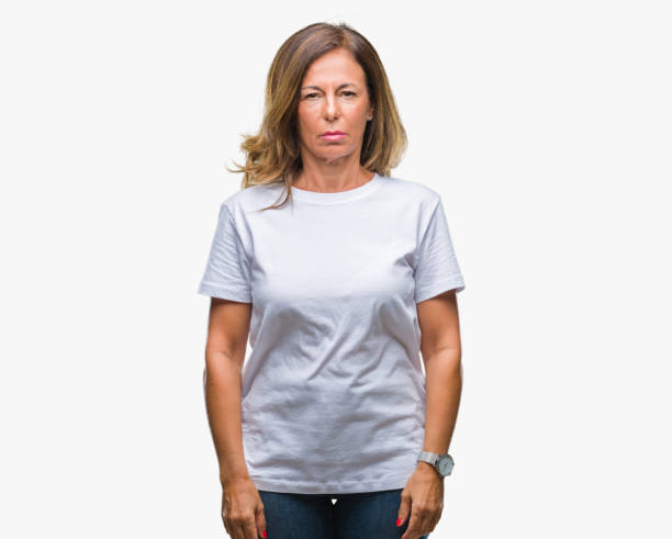 istock Middle age senior hispanic woman over isolated background with serious expression on face. Simple and natural looking at the camera. 1043295676