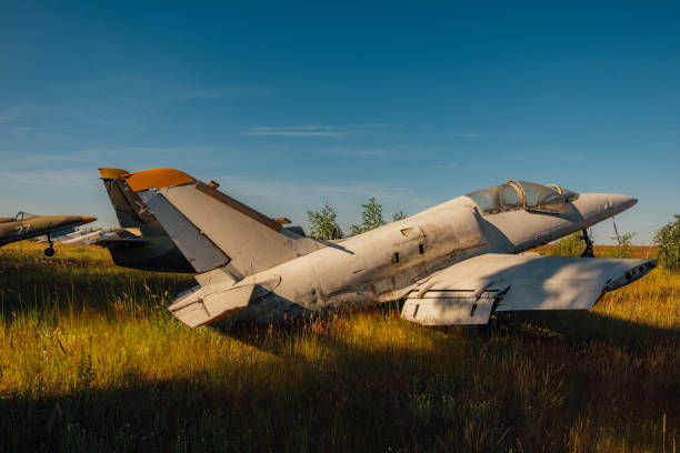 istock Abandoned broken old military fighter airplanes on grassy ground 1043296642