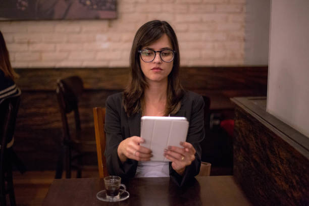 istock Beautiful young woman working in a busy cafe. 1043298940