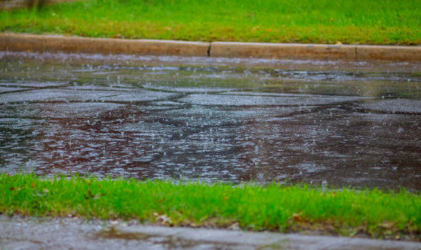 istock raindrops on asphalt road with water ripples during heavy rain 1043298994