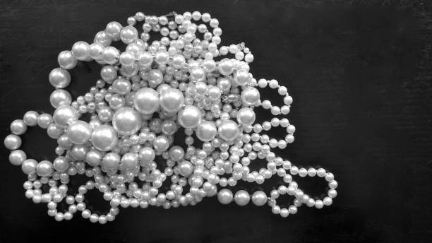 colliers de perles chatoyantes isolées sur fond noir - black pearl pearl horizontal necklace photos et images de collection