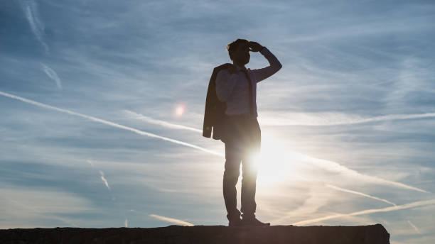 istock Businessman saluting the setting sun 1043299498