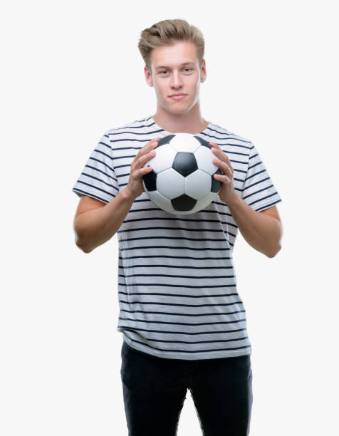 istock Young handsome blond man holding soccer ball with a confident expression on smart face thinking serious 1043303004