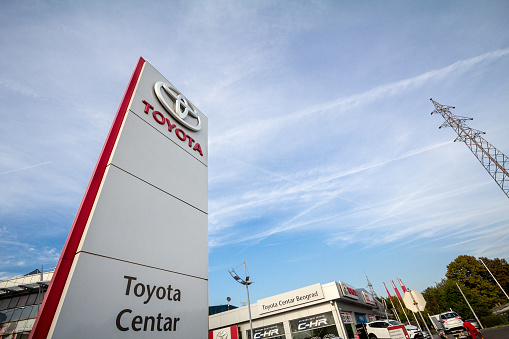 Picture of the Toyota sign with their logo on their car dealership in New Belgrade, taken at sunset. Toyota, is a Japanese multinational automotive manufacturer, the fifth-largest company in the world by revenue