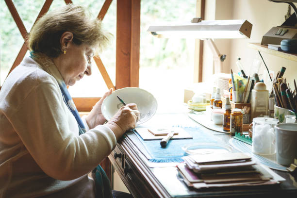 istock Woman painting ceramics 1043310932