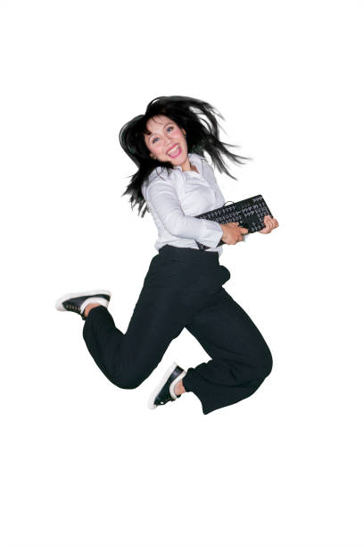 istock Woman jumps in studio with computer keyboard 1043314032