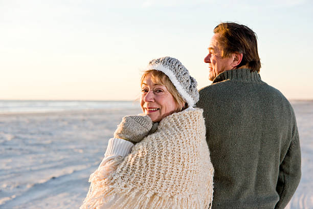 istock Affectionate senior couple in sweaters on beach 104331683